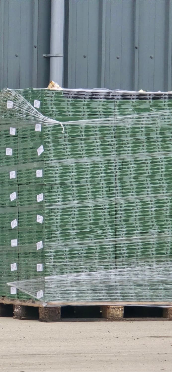 Pallet of crates wrapped in perforated Aerosonic film, airflow visible through the wrap