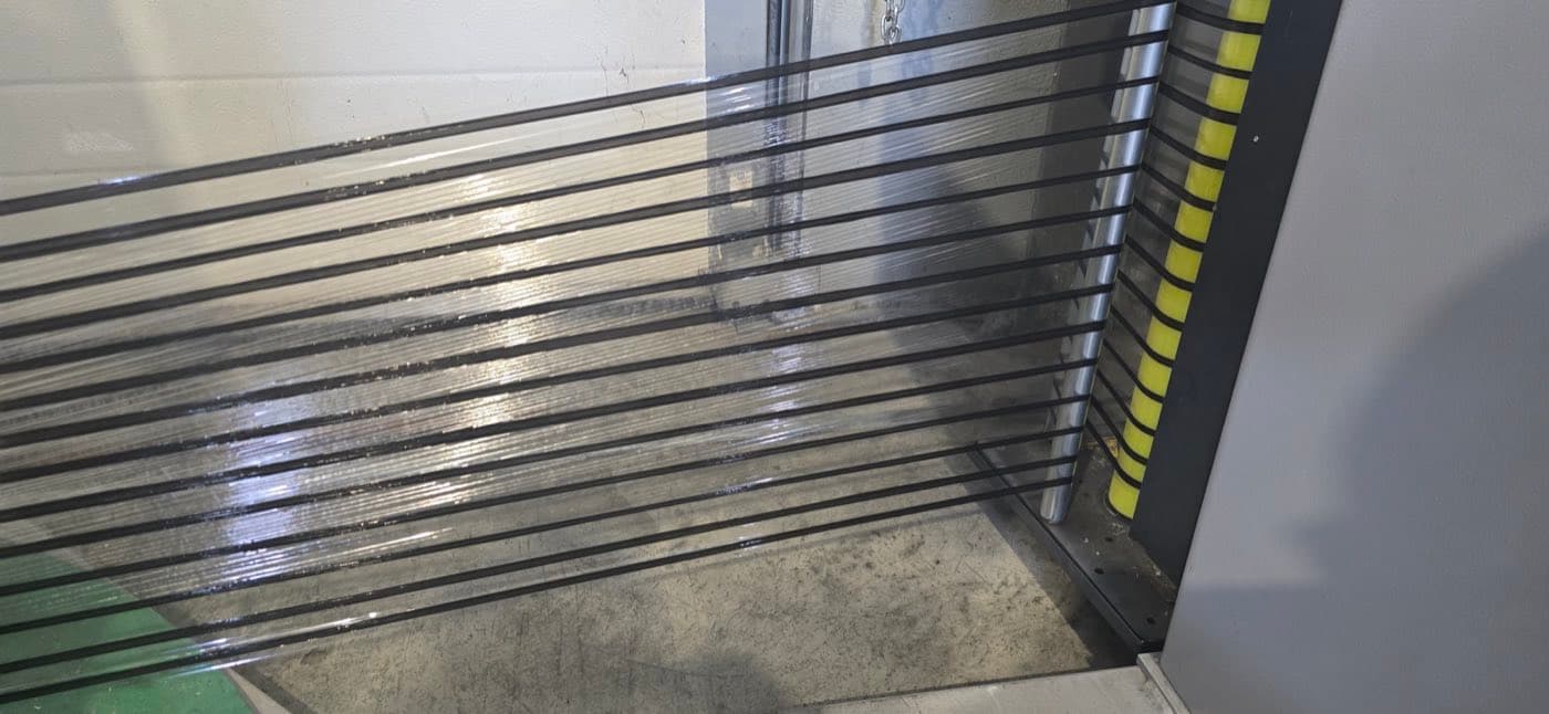 Reinforced film with dark banding holding a stack of glass panels