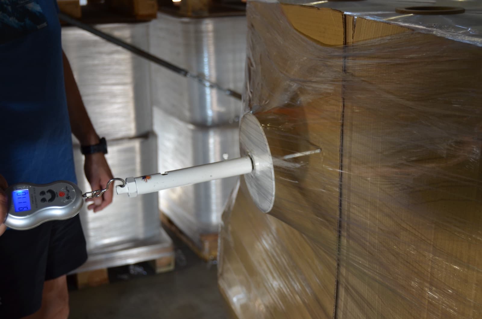 The force gauge pulling against Supersonic on a wrapped pallet during the comparative wrap tests