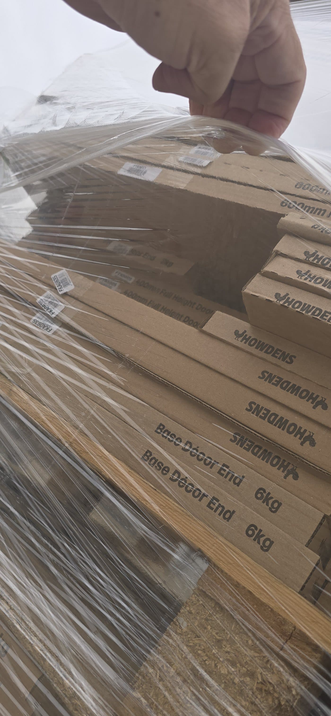 Hyper Wrap film lifted at the top of the load, showing how it is drawn over the top edge of the cartons and back down