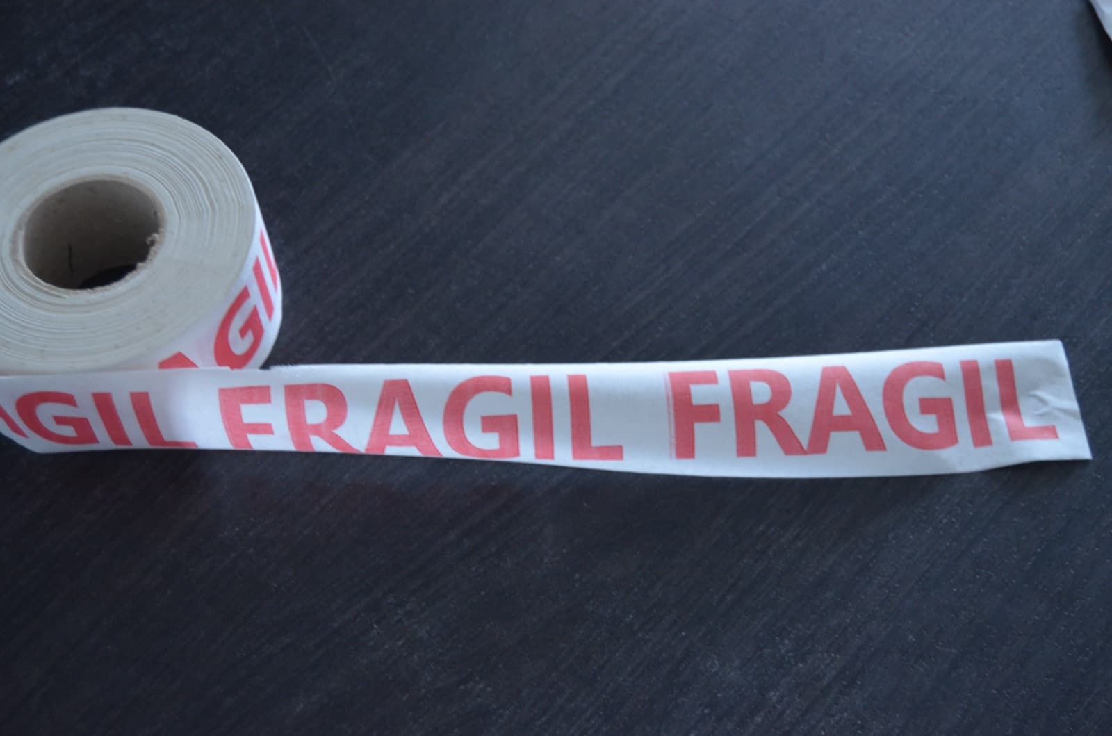 Printed paper gummed tape on the roll, printed FRAGIL in red